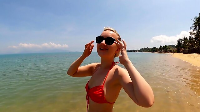 Blonde Ann Joy wearing a red bikini having fun in the sea