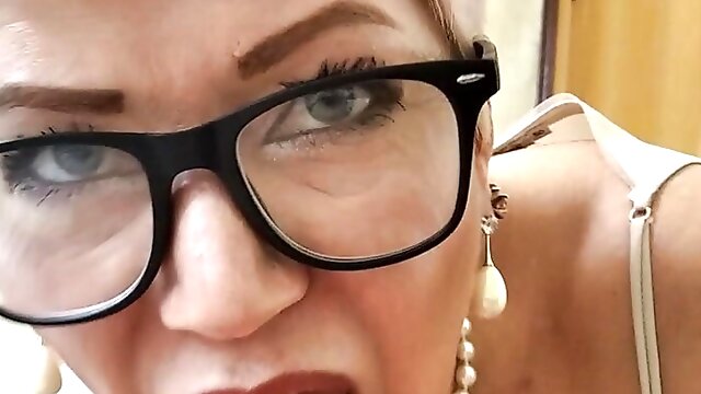 A mature cocksucker with glasses is slapped with a dick on her lips and tongue and cums up on the whore's face...