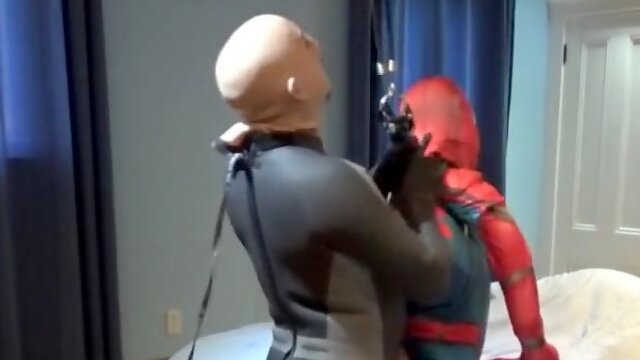 Wetsuited crazy boy plays with his spiderman fool