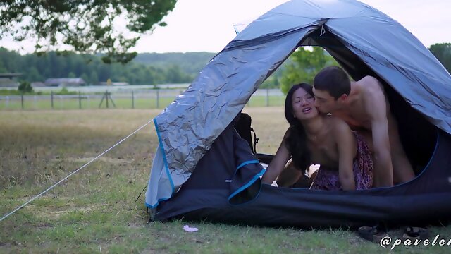 Asian chick is fucking with her boyfriend in a tent outdoors