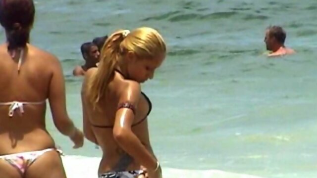 Girl adjust her bathing suit - GNDBeachVideos