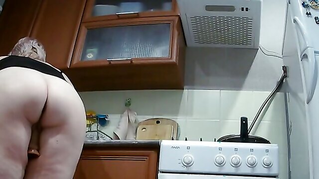 Wife masturbates with sex toys in the kitchen