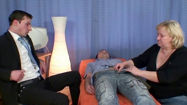 Busty granma in stockings swallows two cocks