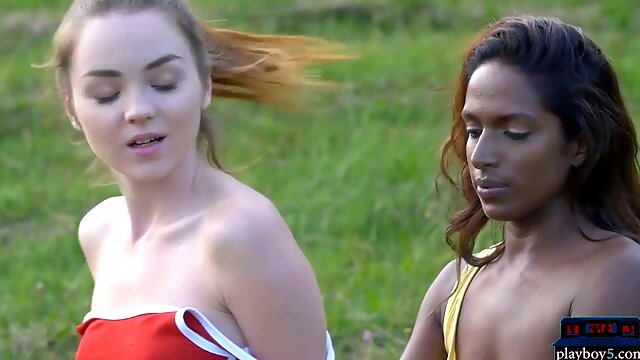 Ebony and creamy skinned lesbians engage in outdoor girl-on-girl fun