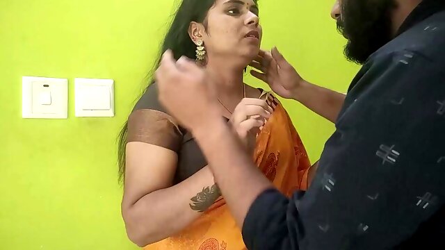 Indian couple in traditional attire shares passionate kisses