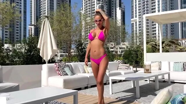 Poses in Pink Bikini and Swims in Pool Surrounded by Skyscrapers