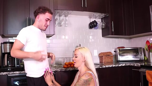 Tattooed Blondie Bombshell with large tits giving a blowjob