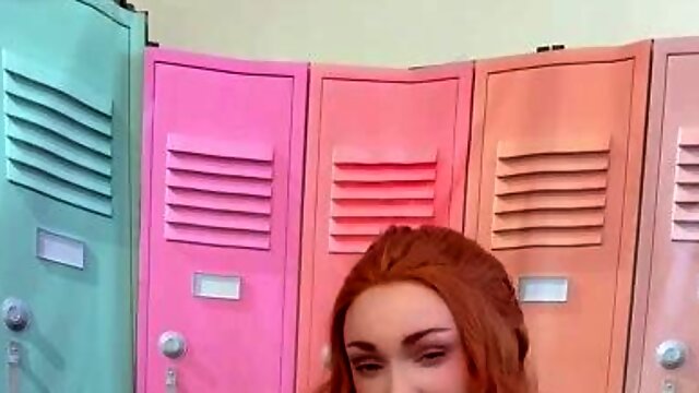 Buxom redhead cheerleader poses and plays with herself
