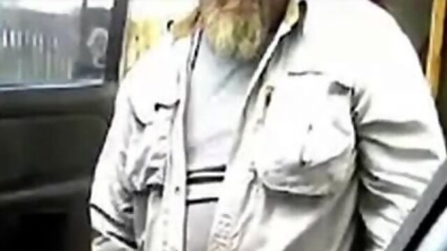 Bearded father masturbates his prick by his camper outdoors.