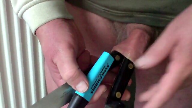 Foreskin with a highlighter and two kitchen utensils