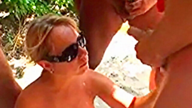 Wild bukkake gangbang for busty MILF on a beach