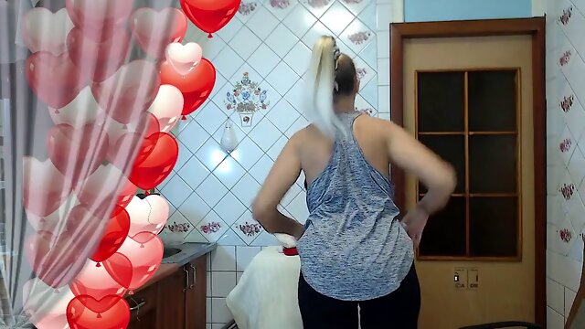 Warm housewife Lukerya at home in the kitchen