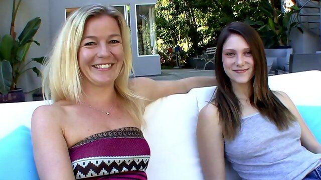 Blonde lesbian MILF fucks younger girl on the couch