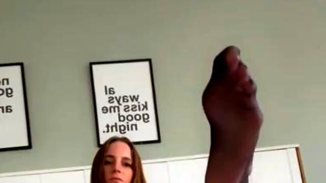 Teen temptress in nylons posing seductively on the bed