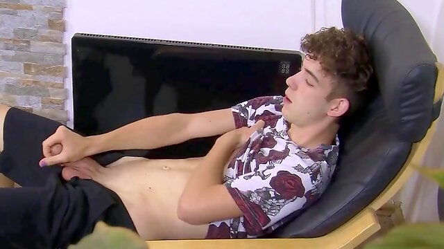 Curly slender guy with big balls jerks off his massive cock