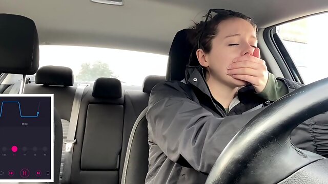 Horny brunette tries to drive a car with a vibrator inside her pussy