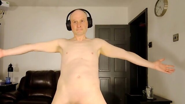 Jonathan dancing freely with headphones, showing off his small uncut cock for his webcam fans