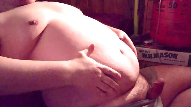 Huge man gets a big belly while sitting and inflating