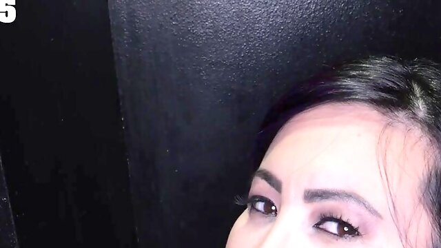 Brunette Lily Lane sucks a big cock through a gloryhole.