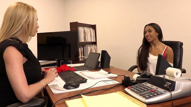 Two hot chicks are having fun in the office with each other