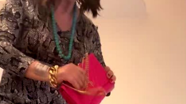 Beautiful Spanish trans girl poses sexy in pretty dress lounge sofa high colorful heels