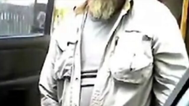 Bearded dad masturbates his shaft by his camper outdoors.