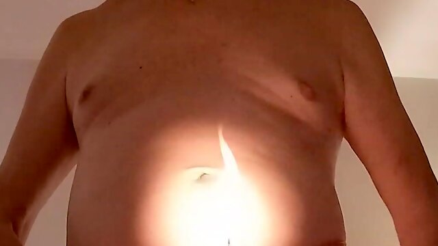 This mature man enjoys putting a lit candle in his dick