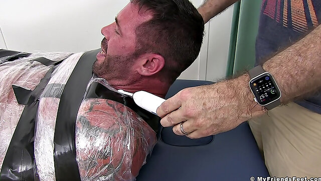 Joey gets tied up and teased with sensual tickling by another man