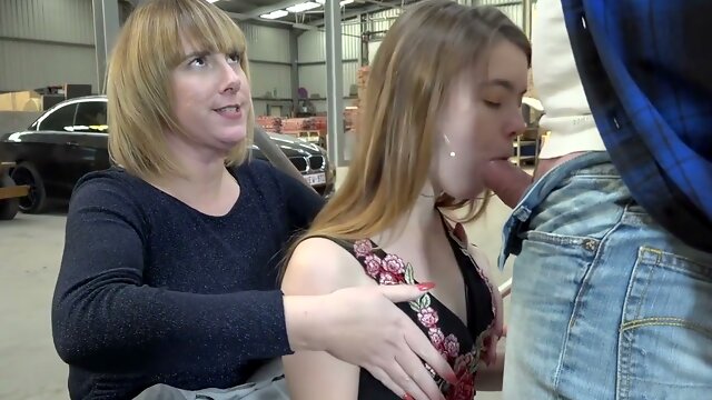 Strict femdom session unfolds in a public warehouse with bondage and deepthroat