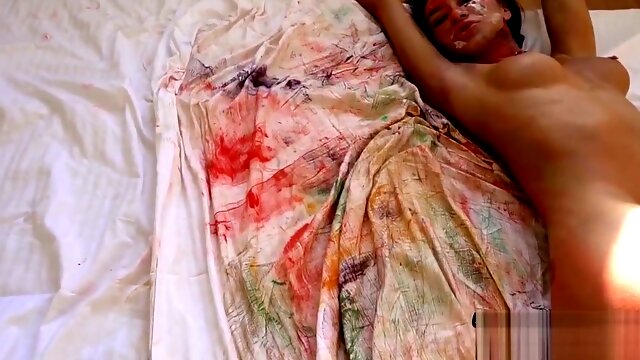 Katrin Tequilas painted body glistens as she explores herself in close-up