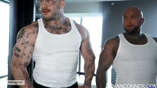 Tattooed blonde and two muscular men heat up in a modern apartment threesome