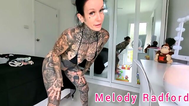 Sun-kissed Australian MILF Melody Radford slowly slips into a tiny red G-string and micro bikini for a private bedroom lingerie session