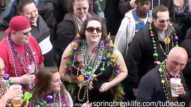 MILF flashes her large breasts during Mardi Gras street celebration