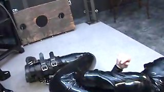 Latex male slut sucks big dildo in spandex porn video