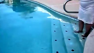 Corpulent granny in nylons plays in the pool