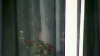 Naked mature woman caught from bedroom window by a voyeur