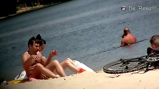 Flat chested brunette and mature blonde on beach voyeur vid