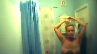 Big breasted blonde captured on a shower spy cam