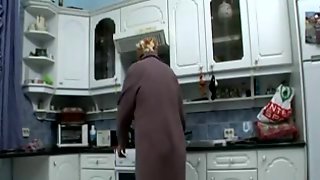 Grandmother masturbates in the kitchen