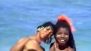 A lucky man on the beach with two ebony nymphs