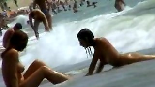 Smoking hot brunettes are relaxing on the nudist beach