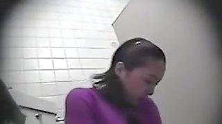 Voyeur hidden camera in a public toilet exposing cunt playing