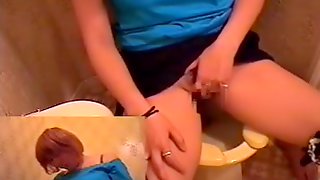 Toilet cam exposing this redhead angel rubbing her clit