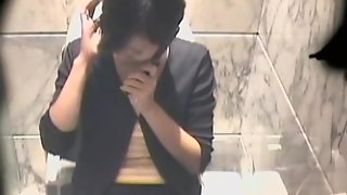 Spy cam recorded an Asian brunette fingering her sissy