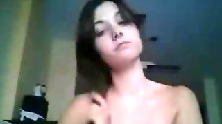 Young brunette demonstrating her saggy tits on webcam