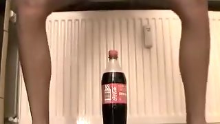 Small  immature tries to ride a coke bottle