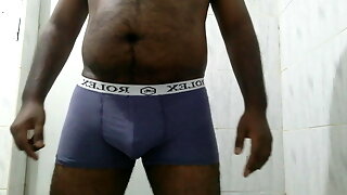 An Asian black boy pissing in his underwear 