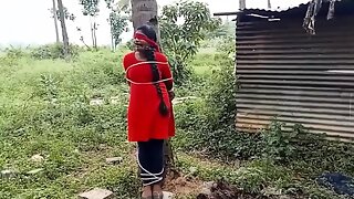 Indian girl tied to a tree