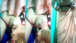 Indian trans woman Gaurisissy pressing and milking her boobs in pink saree
