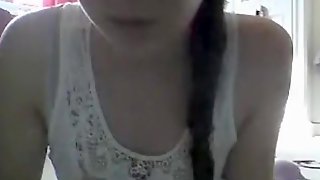 Ponytailed omegle girl plays with a toy on the bedroom floor
